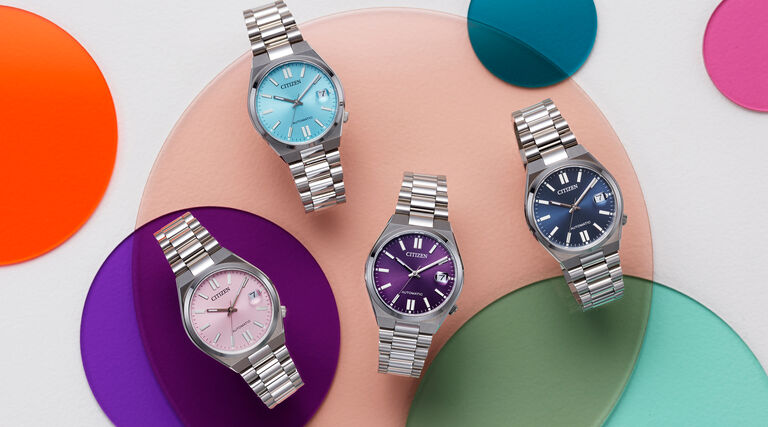 Image of four TSUYOSA 37mm models laying on top a colorful circles background. Image features watch models NJ0200-50L, NJ0200-50Z, NJ0200-50W and NJ0200-50M